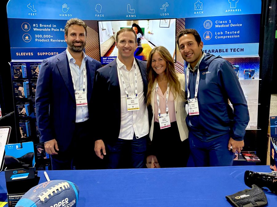 Korie Minkus with the Copper Compression leadership team at their booth