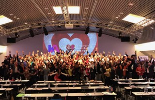 A full room of founders celebrating together on stage