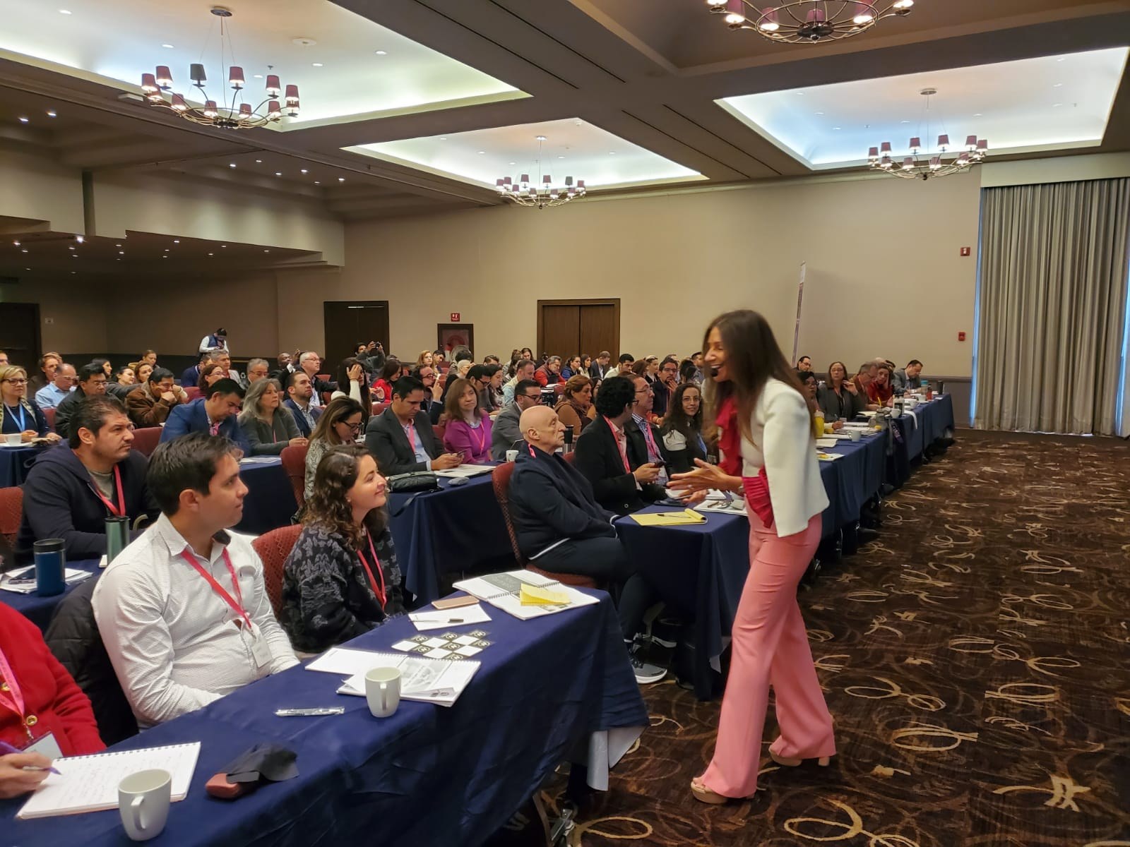 Korie Minkus leading a hands-on workshop in a packed ballroom