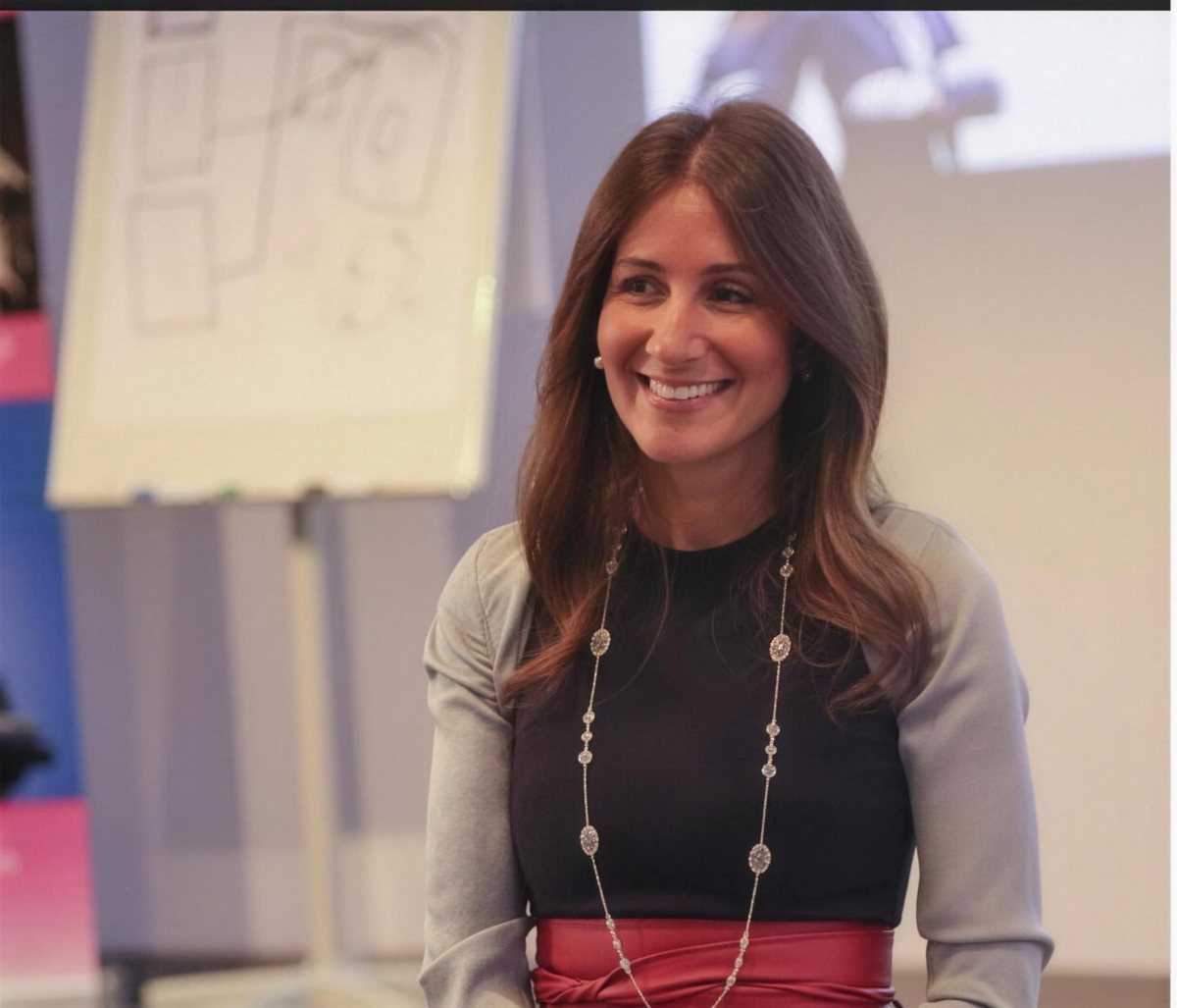 Korie Minkus smiling during a strategy session by a flipchart